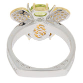 Sterling silver ring featuring an 8X6 green peridot gemstone with elegant butterfly design and accent details.